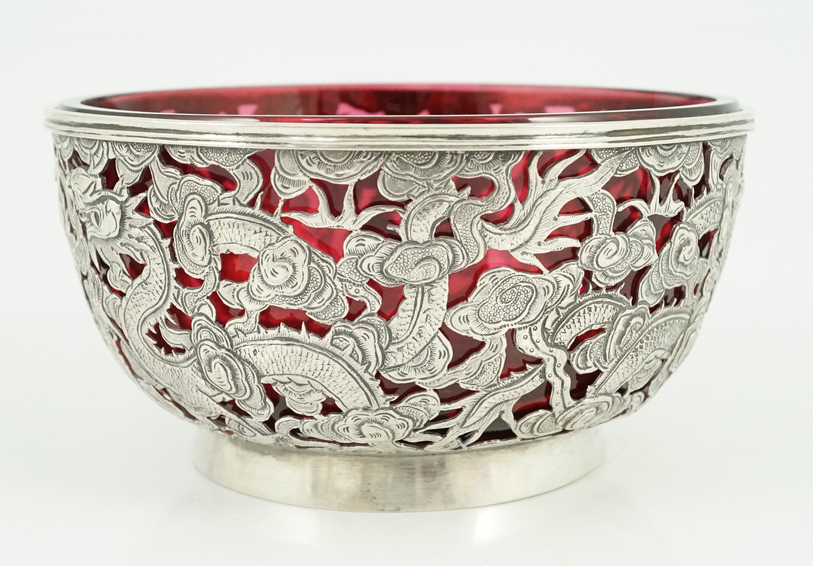 A late 19th/early 20th century Chinese Export pierced silver bowl, by Wang Hing, Hong Kong, with ruby glass liner